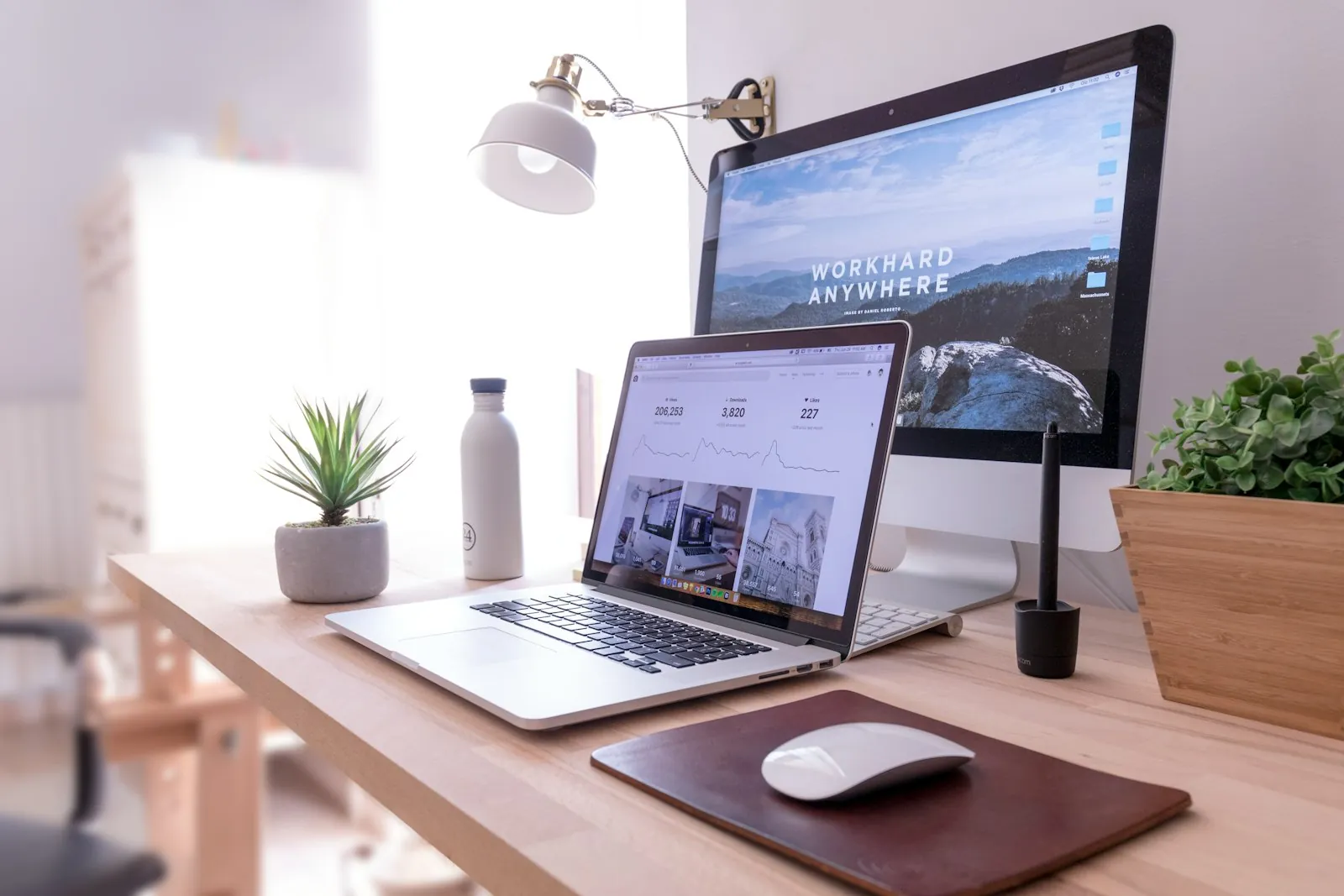 Laptop with a website visitor dashboard and a desktop monitor on a tidy desk – the workspace behind a professional small business website